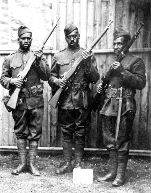 Three black soliders holding rifles