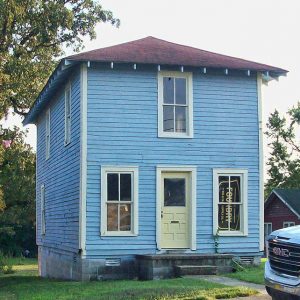 Narrow two-story house with blue paint