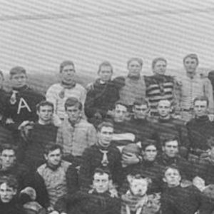 Group of young white men gathered on football field