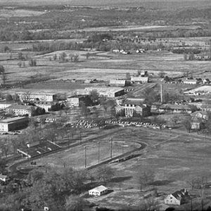 College campus with track and surrounding countryside as seen from above