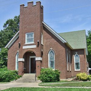 Single-story brick church building with central tower section