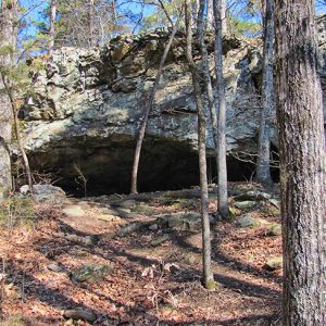 Close-up of cave entrance with rock outcropping