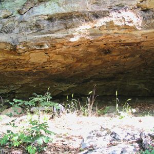 Open space under rock wall