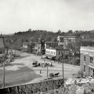 overlook view of town street with hotels and trolley train