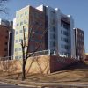 multistory brick steel and glass building labeled "UAMS Biomedical Research Center"