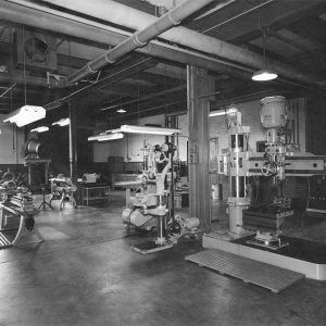 Machinery under fluorescent lights in shop room