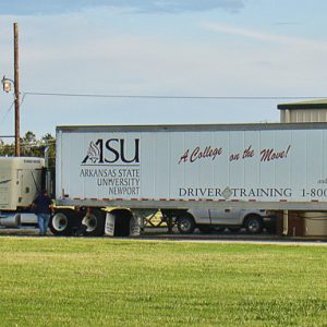 Semi-truck with trailer being serviced with hood up