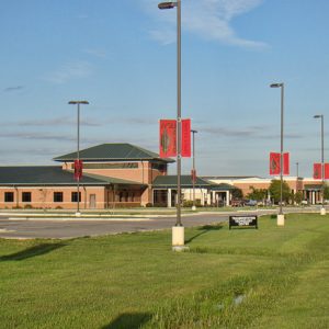 mostly Single-story brick buildings with green roofs and parking lot