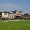 sprawling brick and glass building on green lawn "ASU"