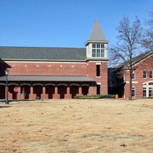 Two-story brick church with steeple and grounds