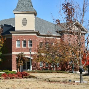 Two-story brick building with tower and grounds