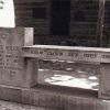 stone bench memorial monument for Cyrus Adler, described as "Scholar Educator Editor Pioneer Leader," in front of log cabin