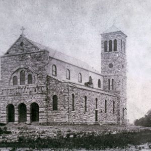 large stone church with bell tower on one end