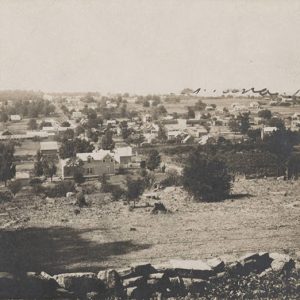 View of town from an elevated position with stone wall in foreground