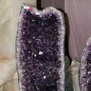 Halved rocks displaying interiors of purple crystal