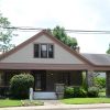 Singe story house with front porch and covered side entrance