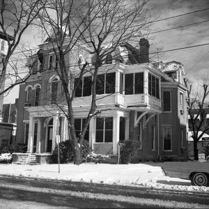 Multistory house with central tower and covered porch in winter