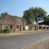 Storefront on street with stone building connected to brick building