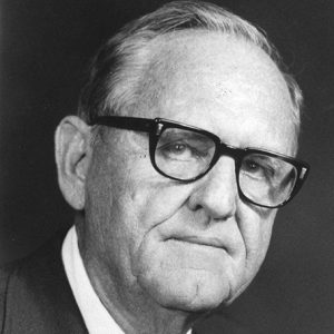 Older white man with glasses in suit and tie