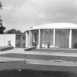 Steps leading up to a large round building with tall glass windows