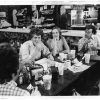 White men and women talking at table in restaurant