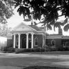 Two-story building with columns and arched windows