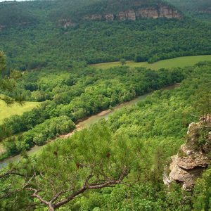 Aerial view of tree covered river valley with rock outcroppings