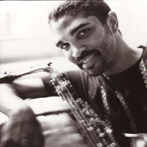 smiling younger African-American man with saxophone