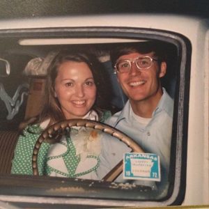 Young white man and woman behind the wheel of a car