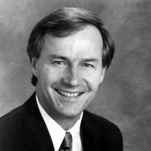 Portrait white man suit and tie smiling with photo backdrop