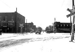 Street scene with brick buildings and railroad crossing