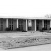 Brick building with columns and grounds with tall narrow windows