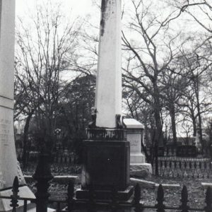 Grave marker standing among others in cemetery