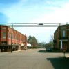 four way intersection with stop signs and two story brick buildings