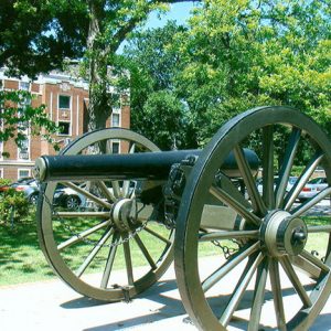 Cannon on wheels with brick court house and grounds