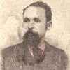 African-American man with beard in suit and tie