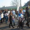 Mixed crowd of people walking on street with protest signs