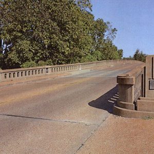 Looking across concrete bridge with railing