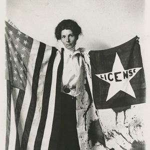 Young white woman standing with flags