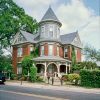 Multistory house with round central tower and covered porch