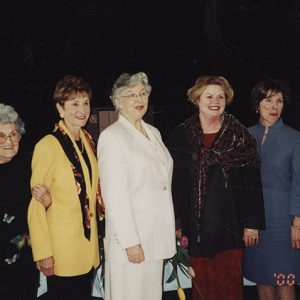 Older African-American woman standing with group of older white women