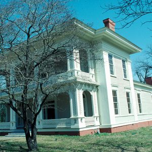 Front view of two-story house with covered porch and balcony