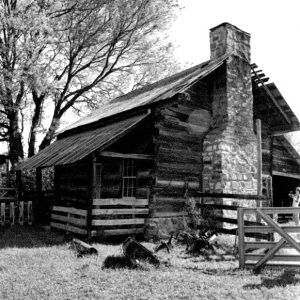 Log cabin with brick chimney and gate