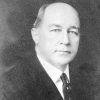 Bald white man in suit and tie