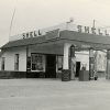 Shell gas station with canopy and gas pumps with car