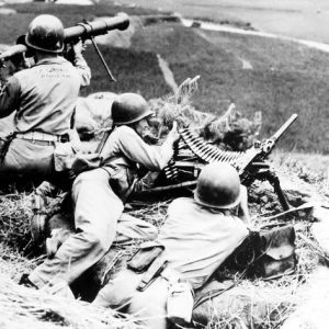 White soldiers with machine gun and bazooka perched on hill side