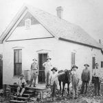 Storefront with white men and horse