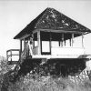 Lookout tower with stone foundation and pyramid shaped roof with stairs