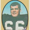 White man in football uniform with "Bill Bergey Bengals" on banner below him and foot ball with "Middle Linebacker" on it