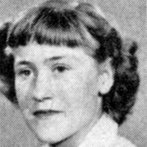 young white woman with wavy hair and bangs cut straight across